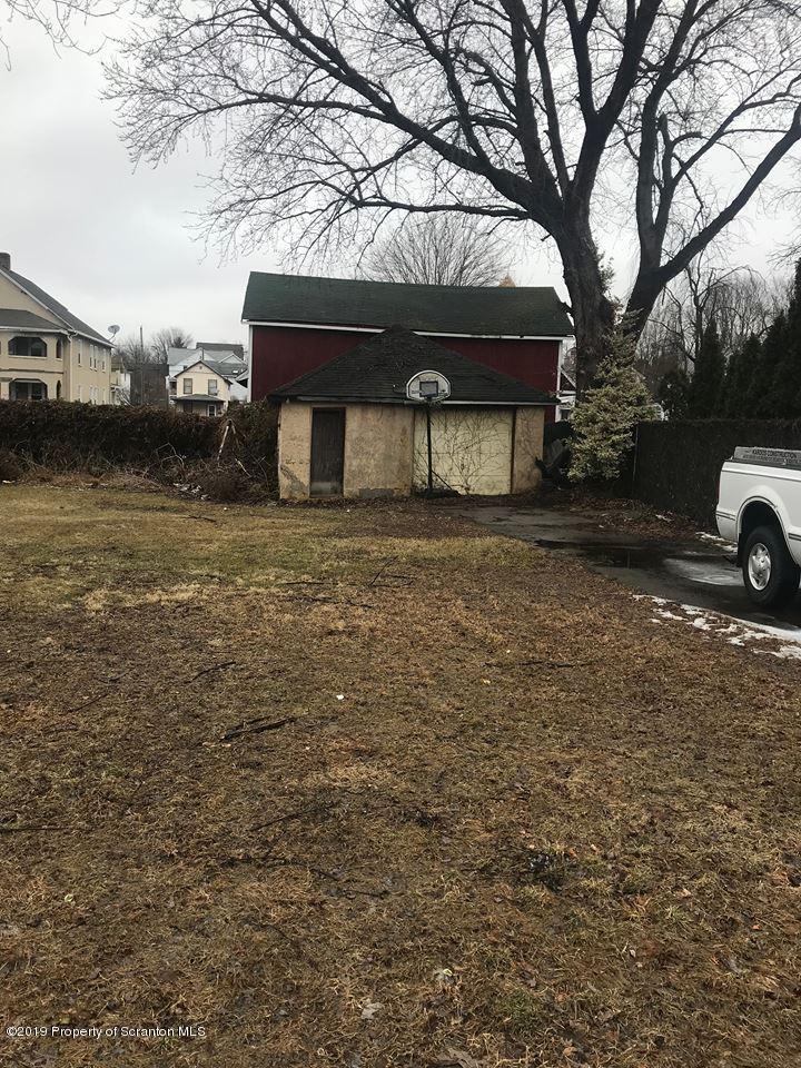 513 Maple Street Old Forge, PA 18518 - Photo 1 of 3 a front view of a house with a yard and garage