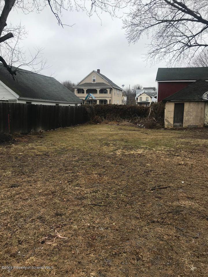 513 Maple Street Old Forge, PA 18518 - Photo 2 of 3 a side view of a house with a yard