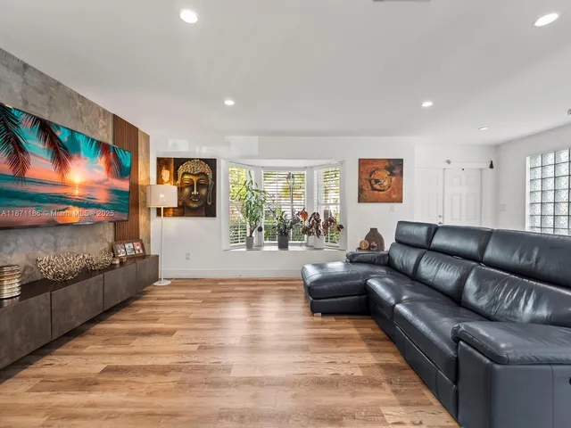 a living room with furniture and wooden floor
