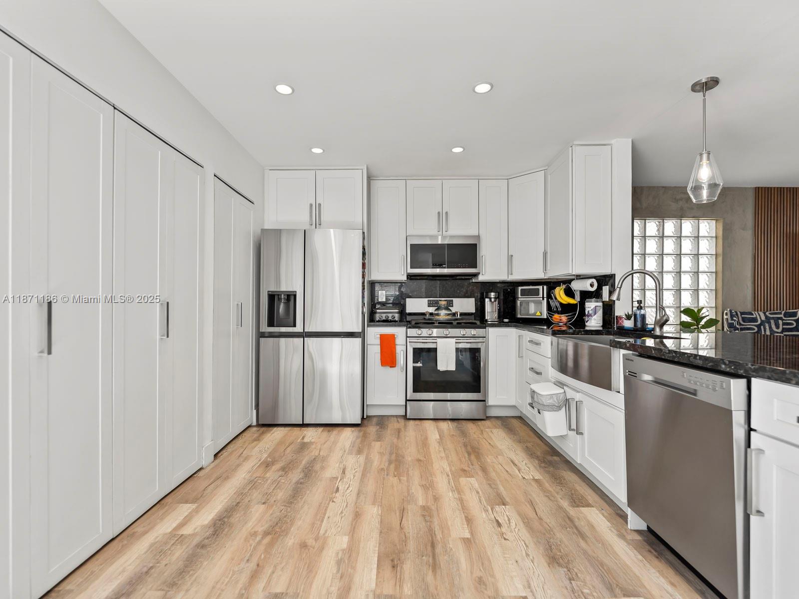 15293 Southwest 111th Street Miami, FL 33196 - Photo 19 of 32 a kitchen with stainless steel appliances a refrigerator sink and microwave