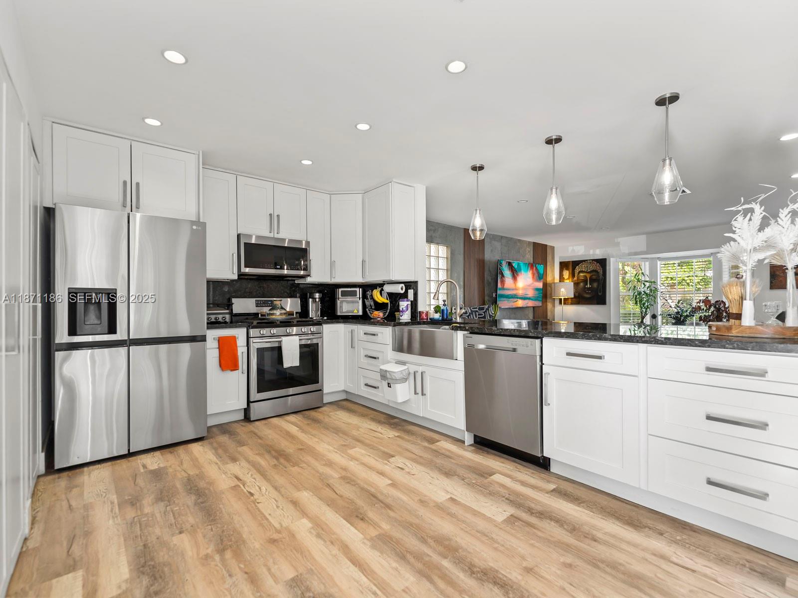 15293 Southwest 111th Street Miami, FL 33196 - Photo 21 of 32 a kitchen with stainless steel appliances a refrigerator sink and microwave