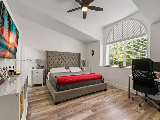 a bed room with a bed and a television