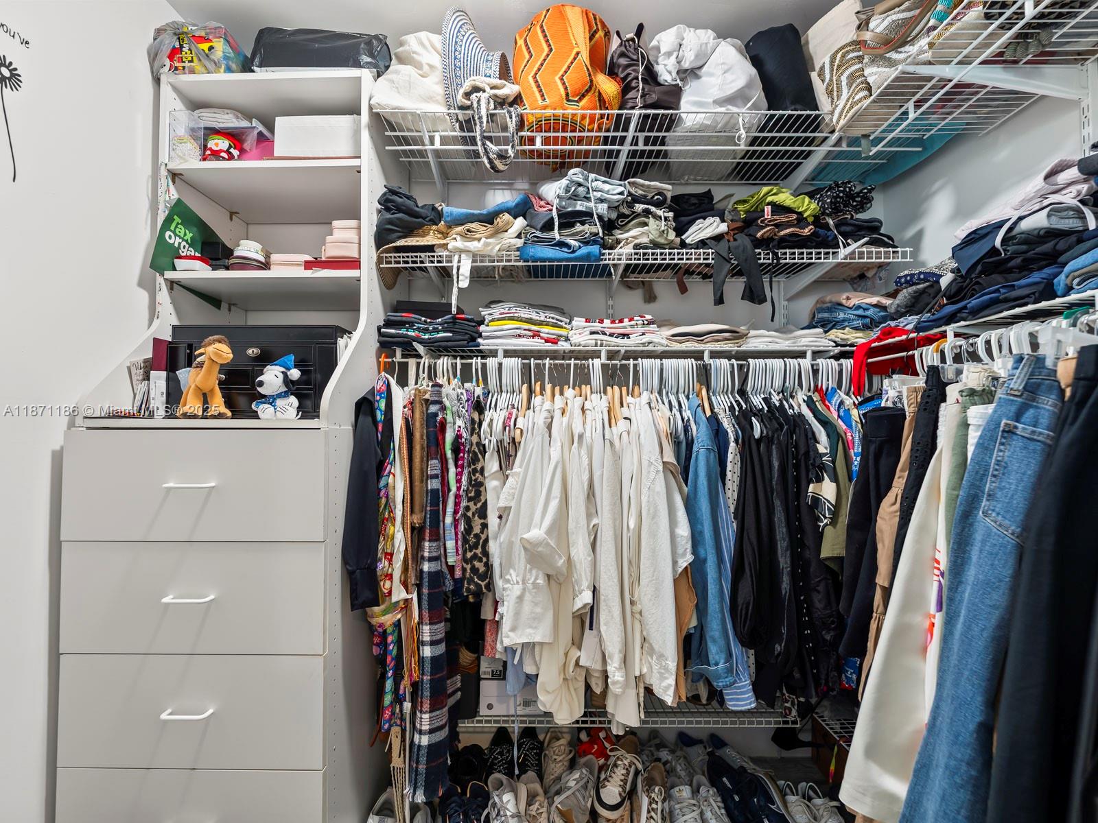 15293 Southwest 111th Street Miami, FL 33196 - Photo 25 of 32 a view of walk in closet with clothes and shoes