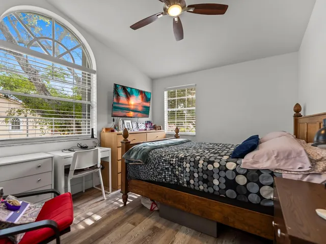 a bedroom with a bed and wooden floor