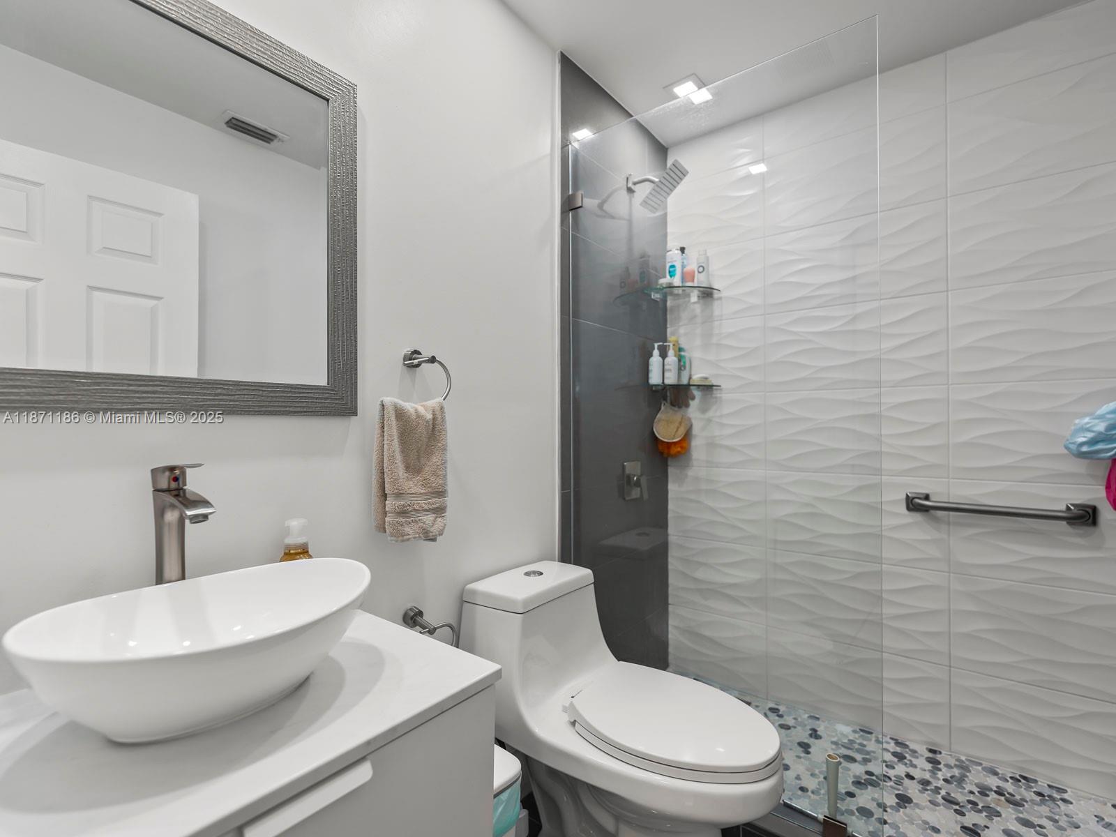 15293 Southwest 111th Street Miami, FL 33196 - Photo 28 of 32 a white toilet sitting next to a bathroom sink