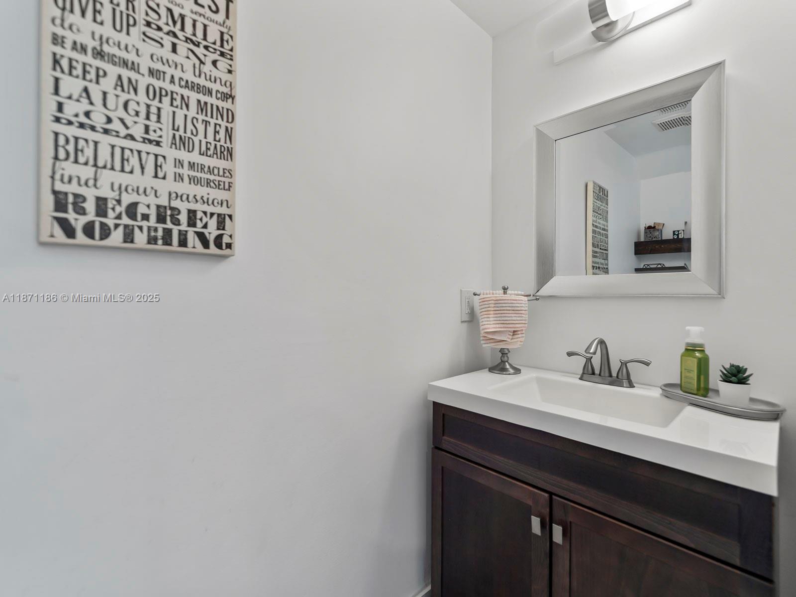 15293 Southwest 111th Street Miami, FL 33196 - Photo 29 of 32 a bathroom with a sink and a mirror