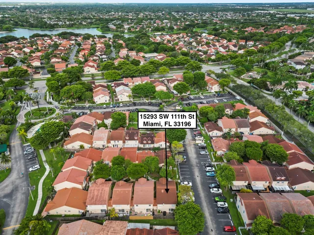 an aerial view of lake and residential houses with outdoor space