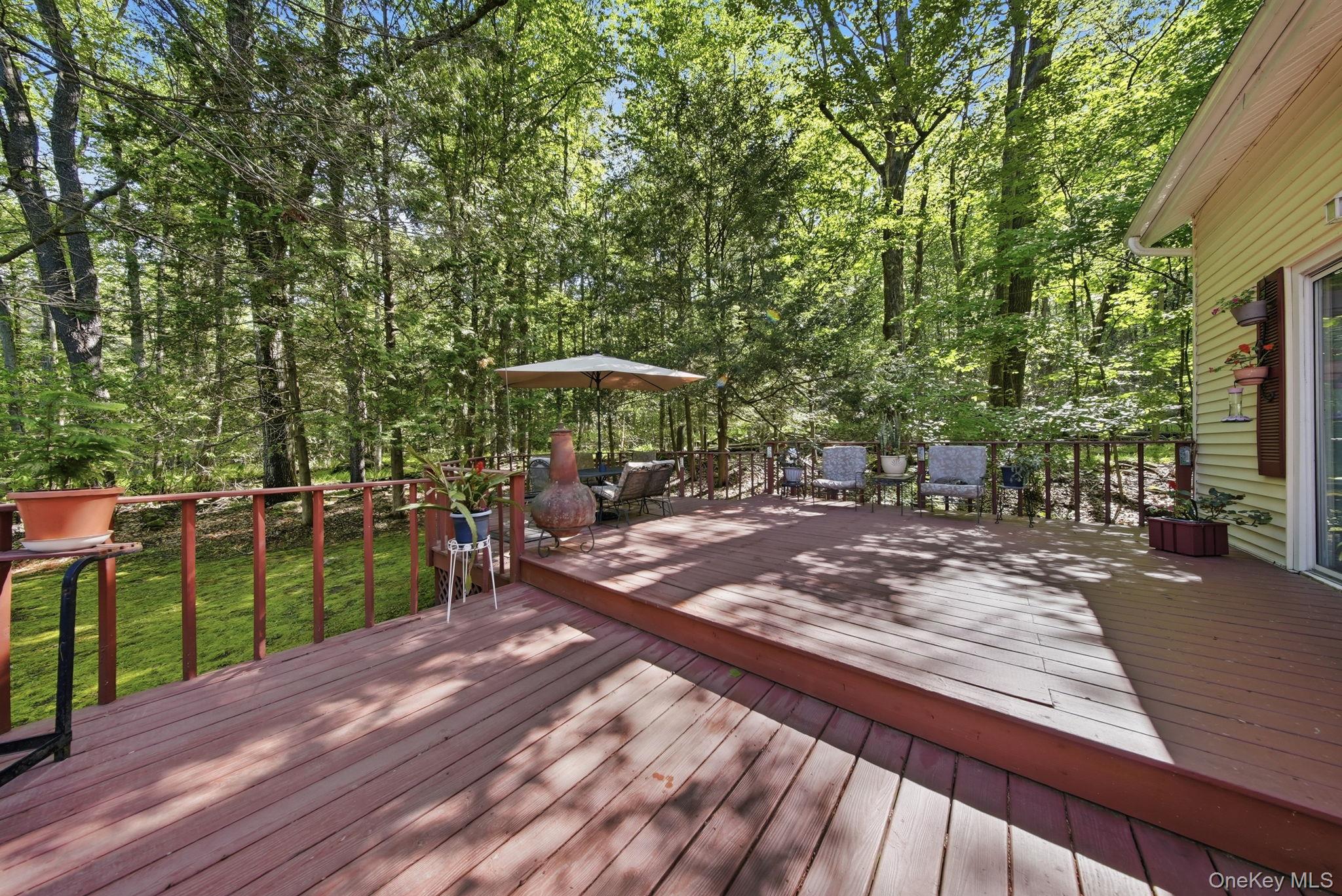 370 Starlight Road Monticello, NY 12701 - Photo 39 of 49 a view of a patio with wooden floor and seating space