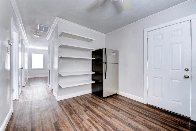 a view of walk in closet with wooden floor