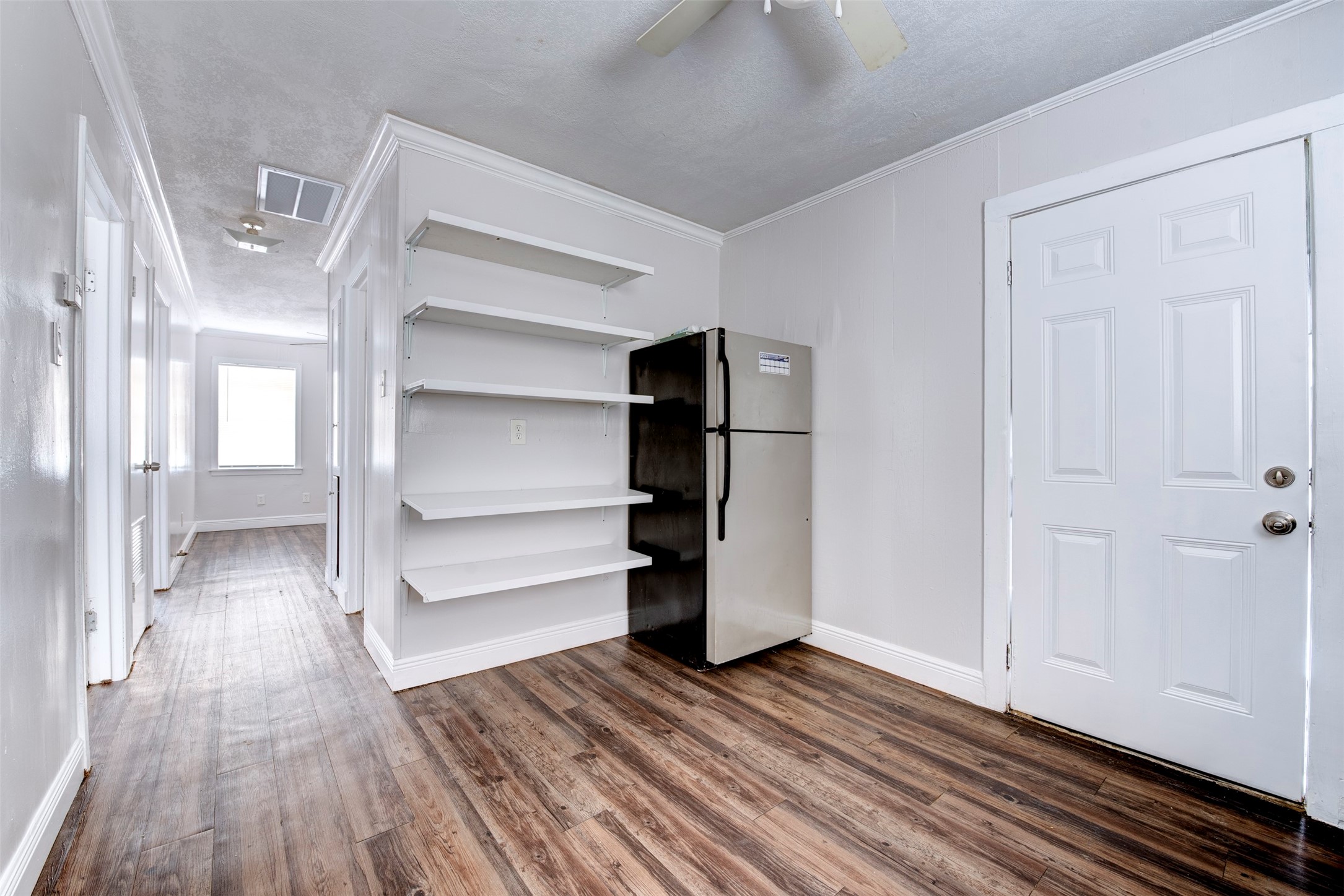 1209 Cabell Street Houston, TX 77022 - Photo 11 of 16 a view of walk in closet with wooden floor