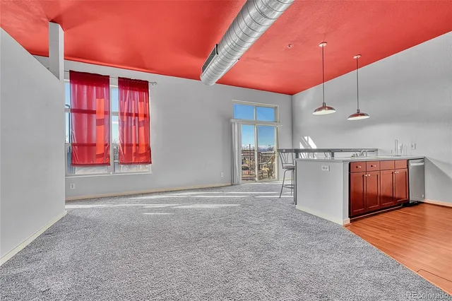 an empty room with windows and closet