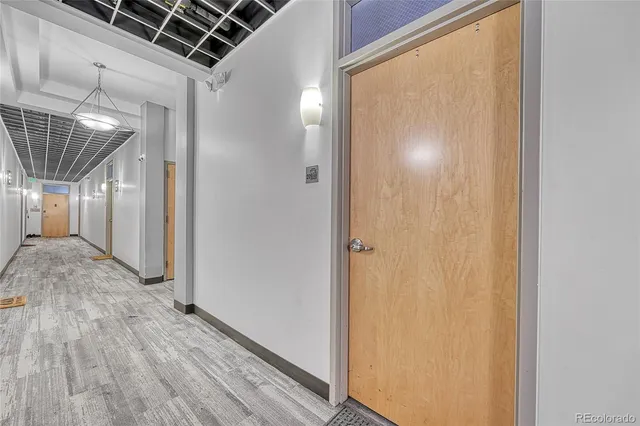 a view of hallway with wooden floor