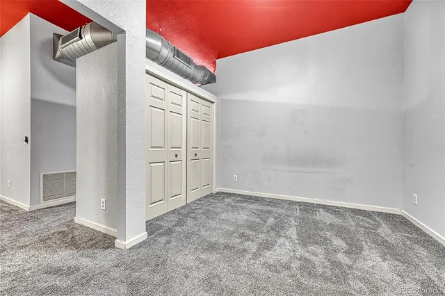 an empty room with closet area