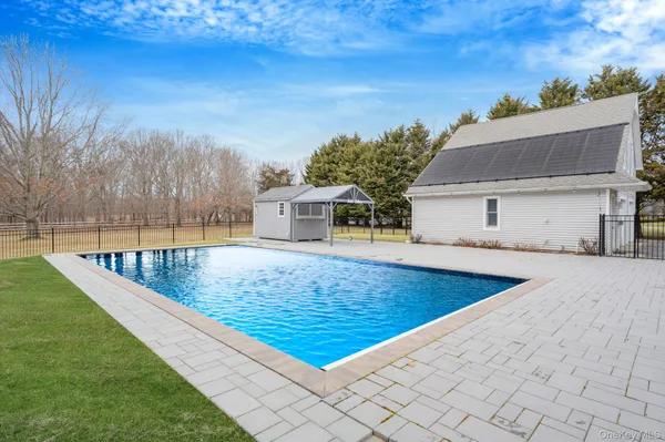 a view of a backyard with a swimming pool