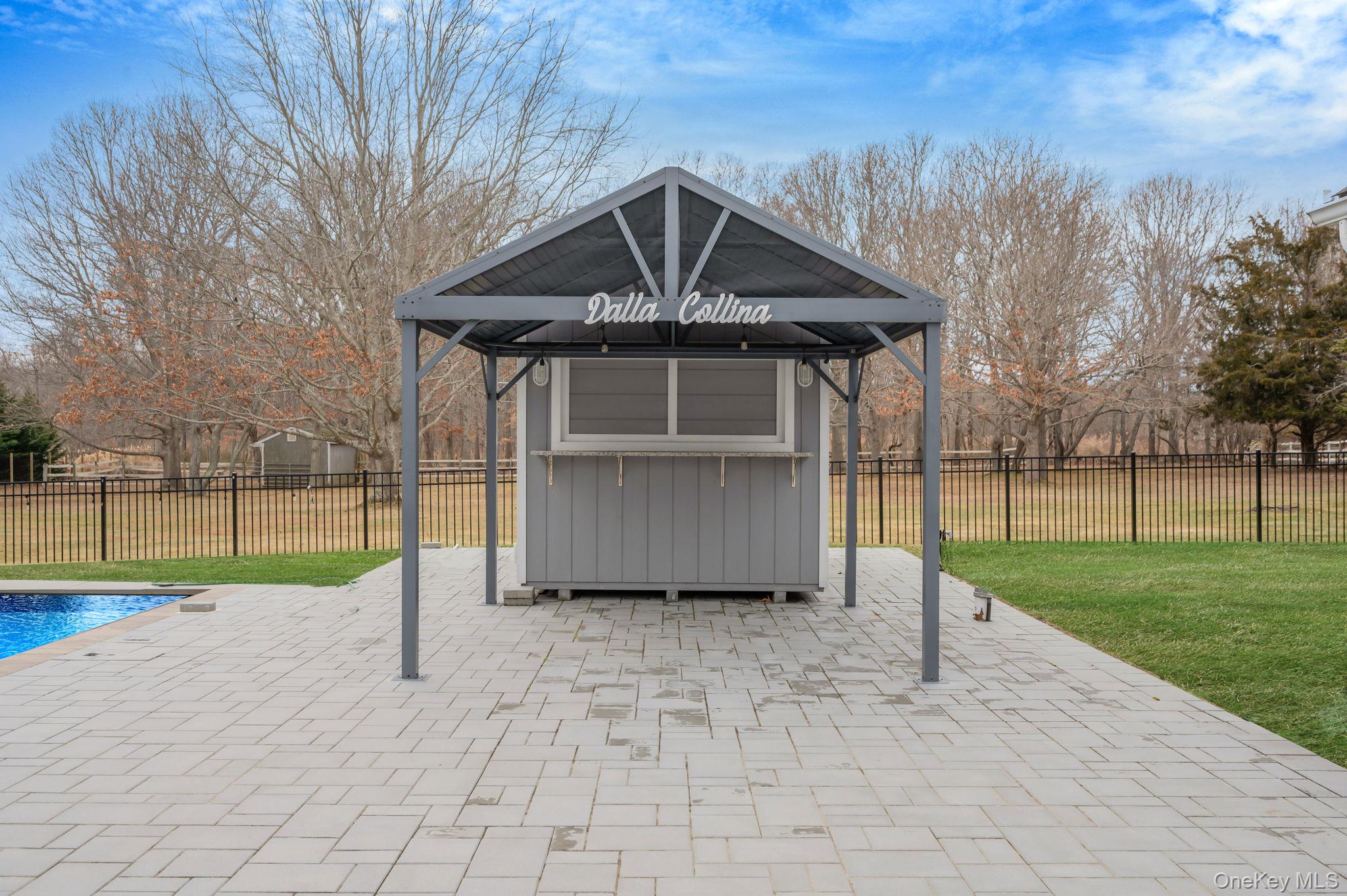 300 Private Road, Unit 8 Cutchogue, NY 11935 - Photo 12 of 47 a view of a small house in front of a house with a wooden fence