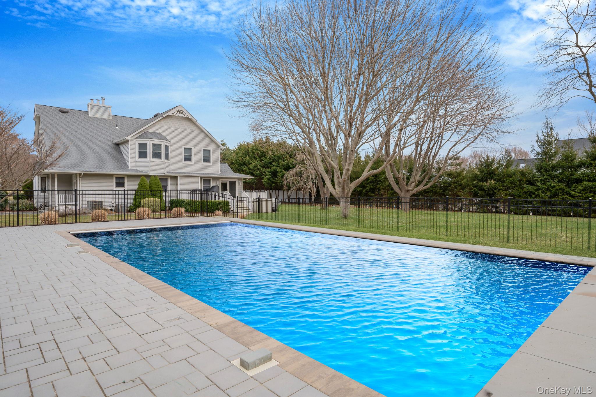 300 Private Road, Unit 8 Cutchogue, NY 11935 - Photo 14 of 47 a view of a house with a swimming pool