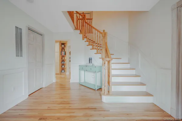 a view of an entryway with wooden floor