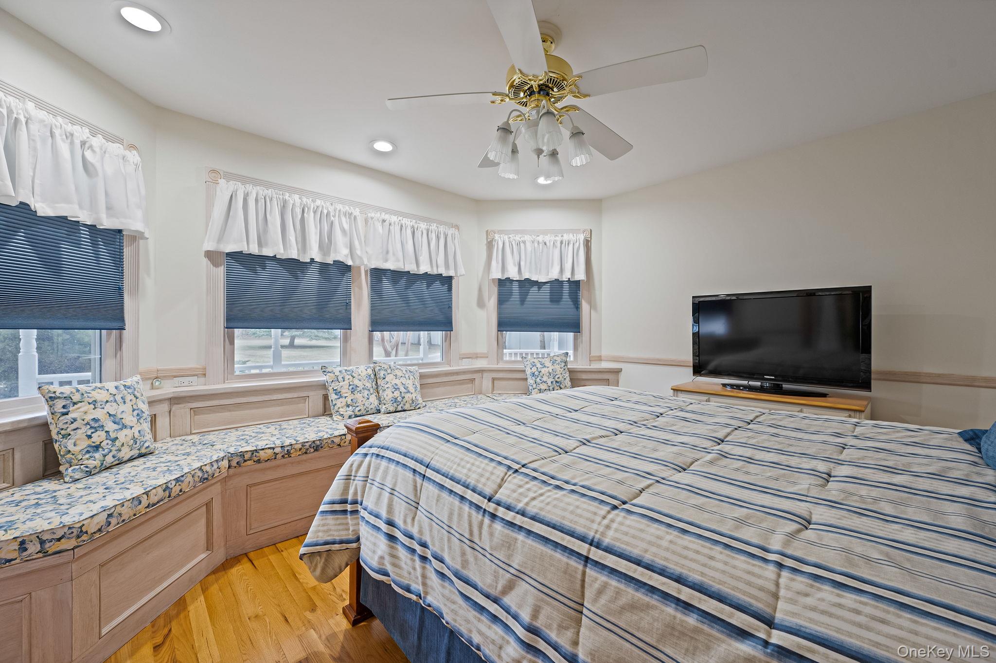 300 Private Road, Unit 8 Cutchogue, NY 11935 - Photo 18 of 47 a bedroom with a bed and a flat screen tv