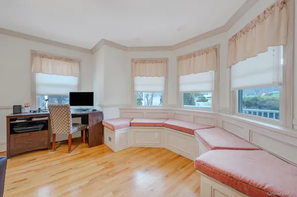 a view of a dining room with furniture wooden floor and a chandelier