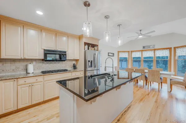 a kitchen with granite countertop a sink and a stove