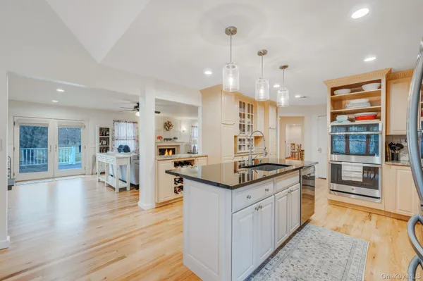a spacious bedroom with a bed and a view of kitchen