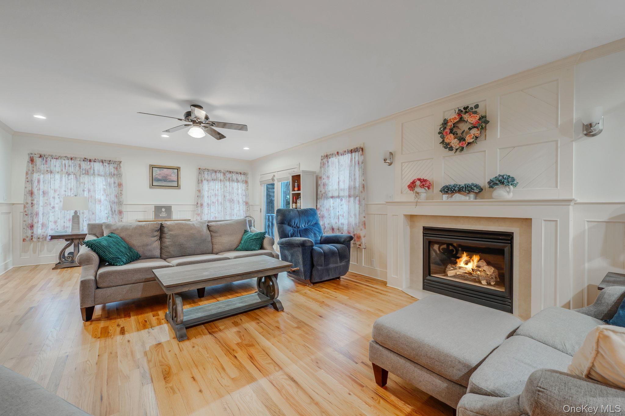 300 Private Road, Unit 8 Cutchogue, NY 11935 - Photo 27 of 47 a living room with furniture and a fireplace