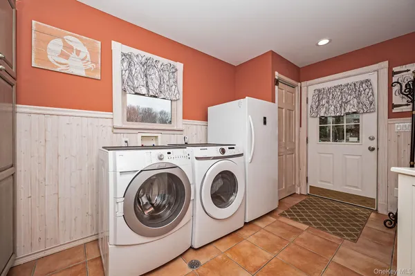 a utility room with closet a washer and dryer