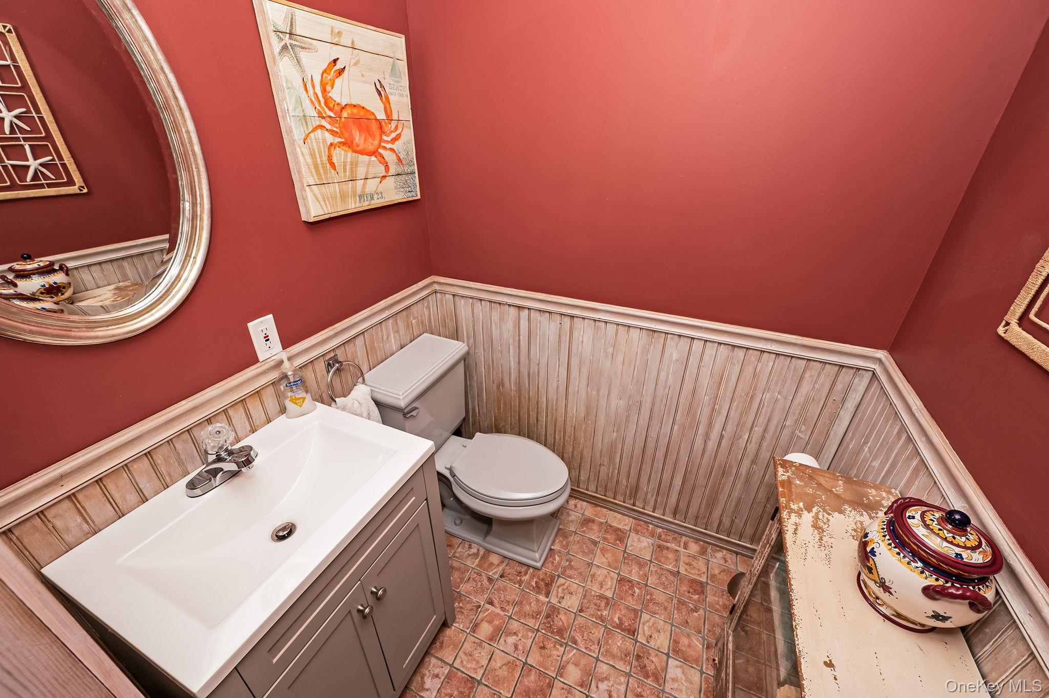300 Private Road, Unit 8 Cutchogue, NY 11935 - Photo 30 of 47 a bathroom with a toilet a sink and a mirror