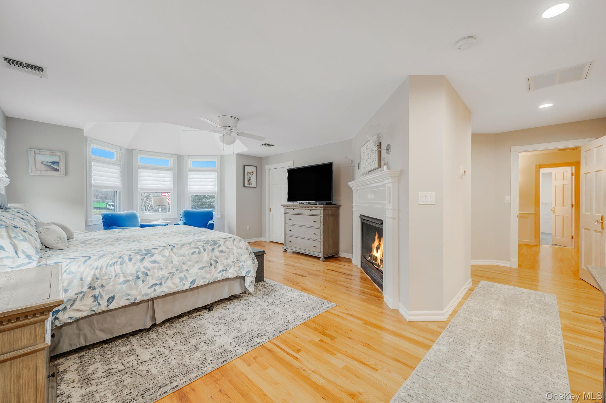 300 Private Road, Unit 8 Cutchogue, NY 11935 - Photo 36 of 47 a spacious bedroom with a bed and a flat screen tv