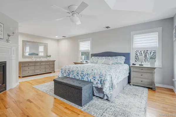 a large bedroom with a bed and a flat screen tv