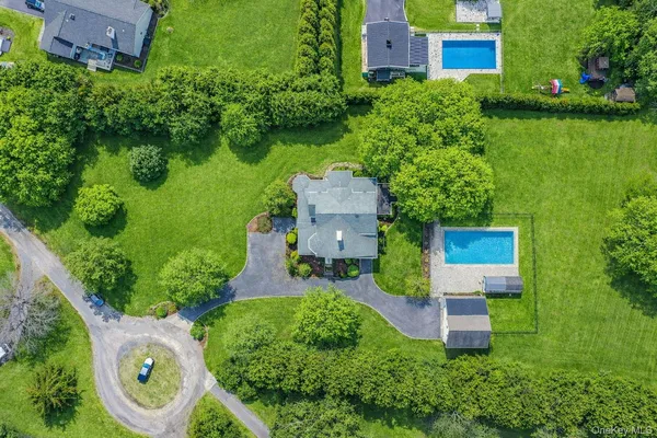 an aerial view of a house with garden space and street view
