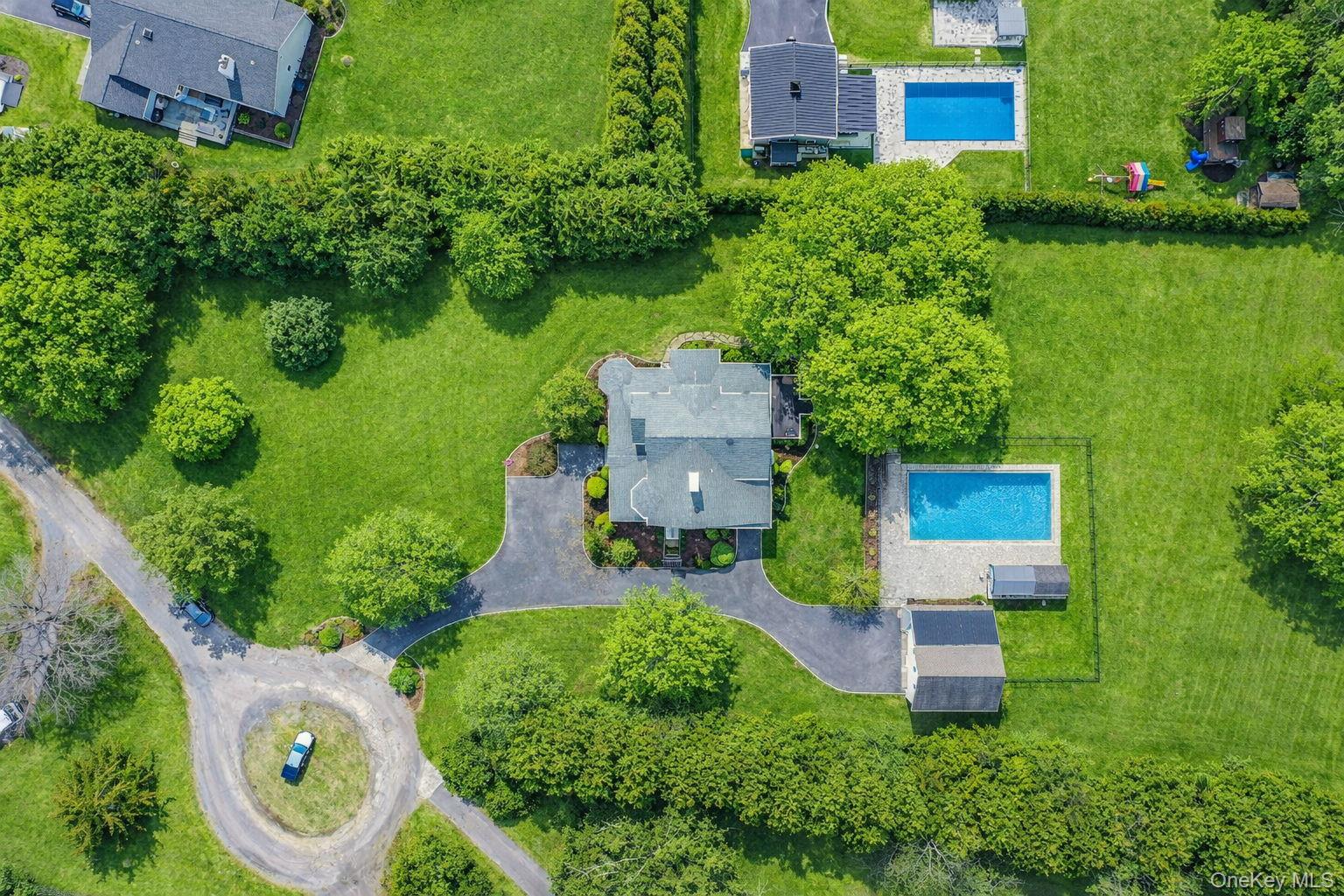300 Private Road, Unit 8 Cutchogue, NY 11935 - Photo 5 of 47 an aerial view of a house with garden space and street view