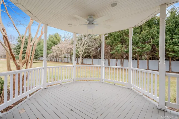 a view of a deck with wooden floor and fence