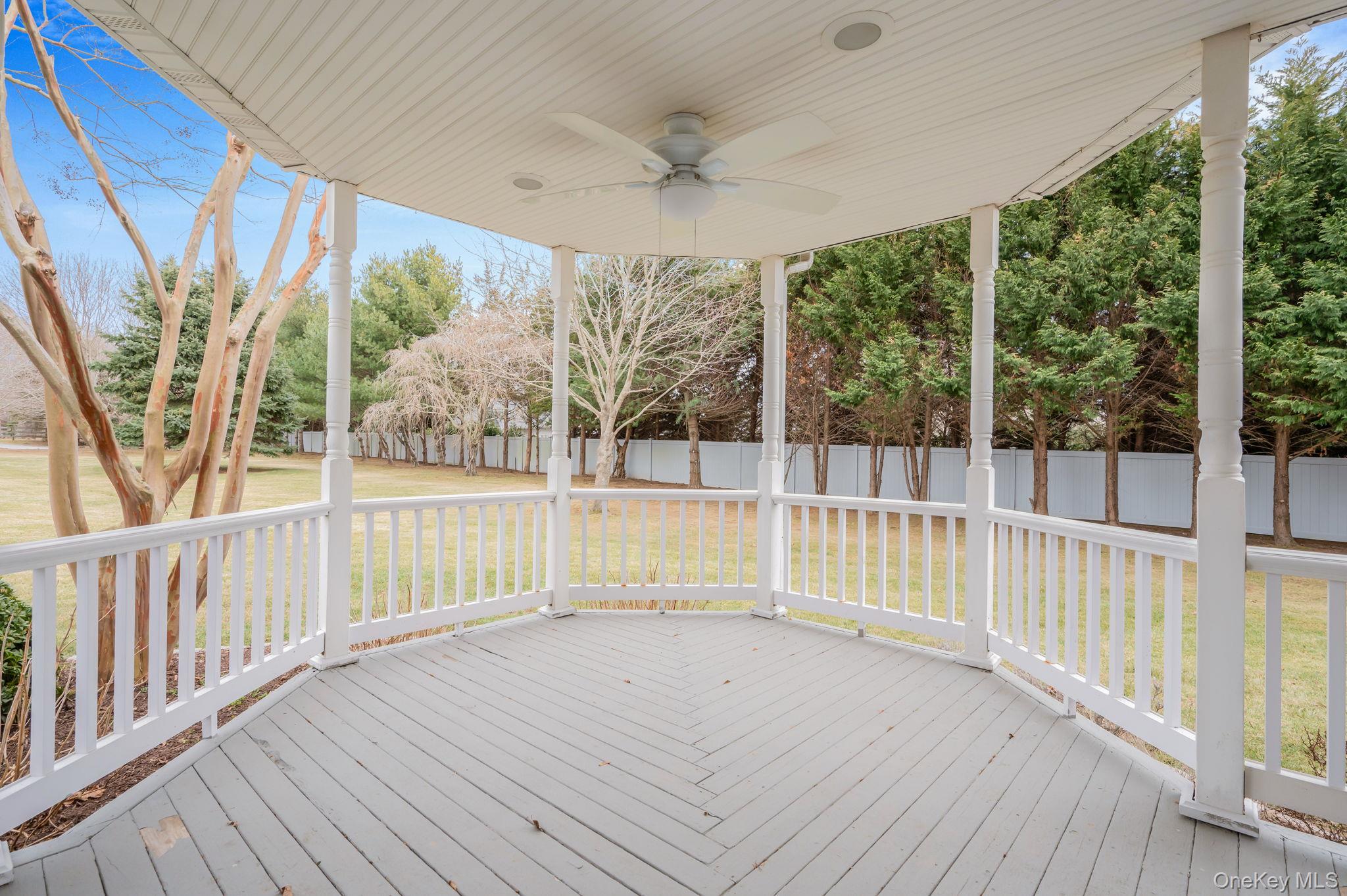 300 Private Road, Unit 8 Cutchogue, NY 11935 - Photo 7 of 47 a view of a deck with wooden floor and fence