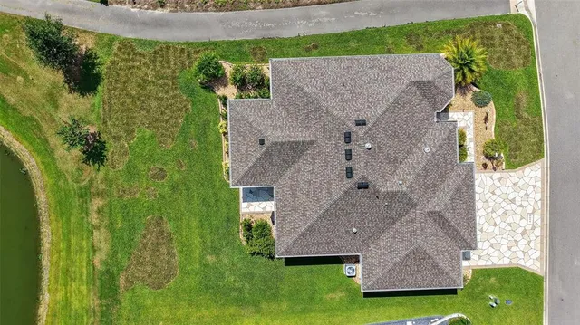 an aerial view of a house with a yard