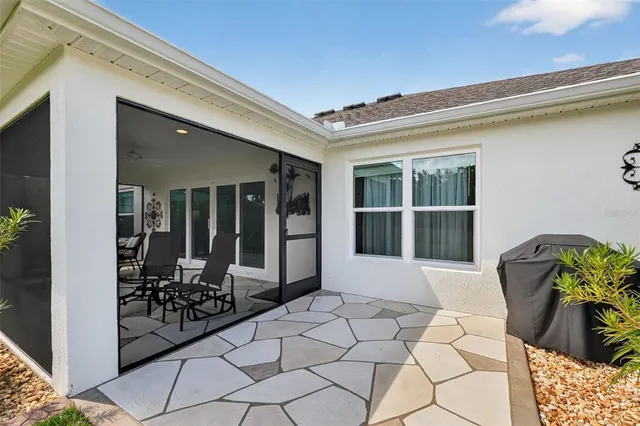 a view of a balcony with chair and potted plants