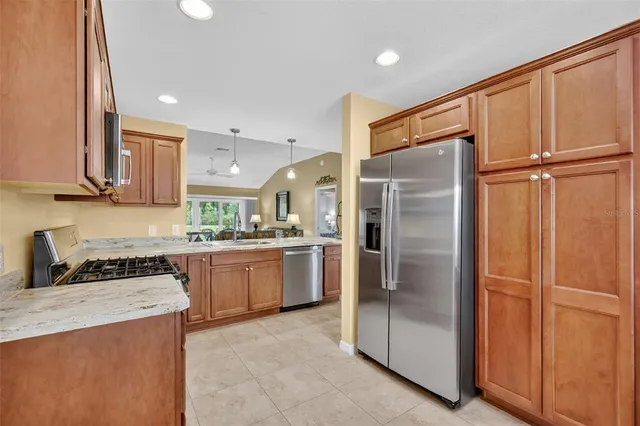 a kitchen with granite countertop a refrigerator and a sink