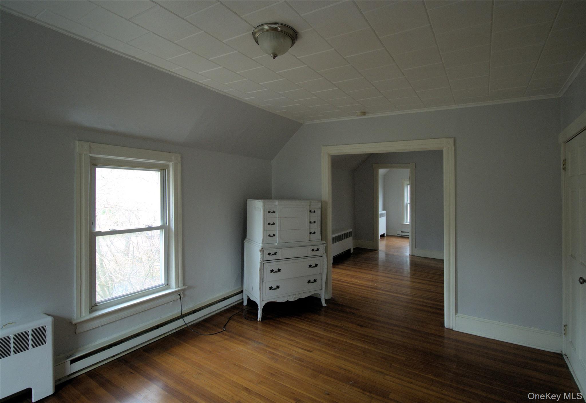 9 Spring Street Liberty, NY 12754 - Photo 18 of 29 Room with wood-finish flooring, light gray walls, and white trim
