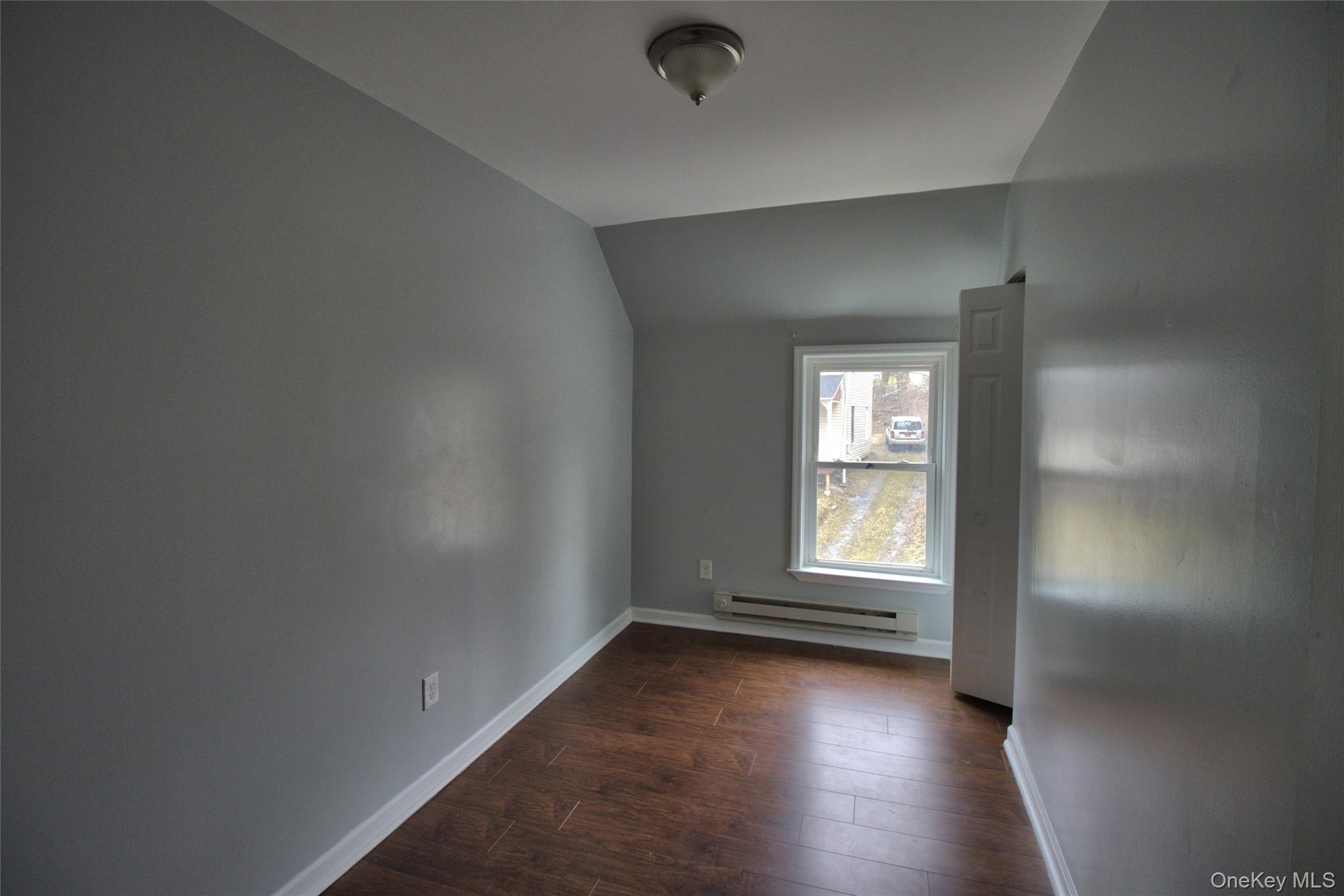 9 Spring Street Liberty, NY 12754 - Photo 22 of 29 Compact room featuring wood-finish flooring, light gray wall paint, and white trim