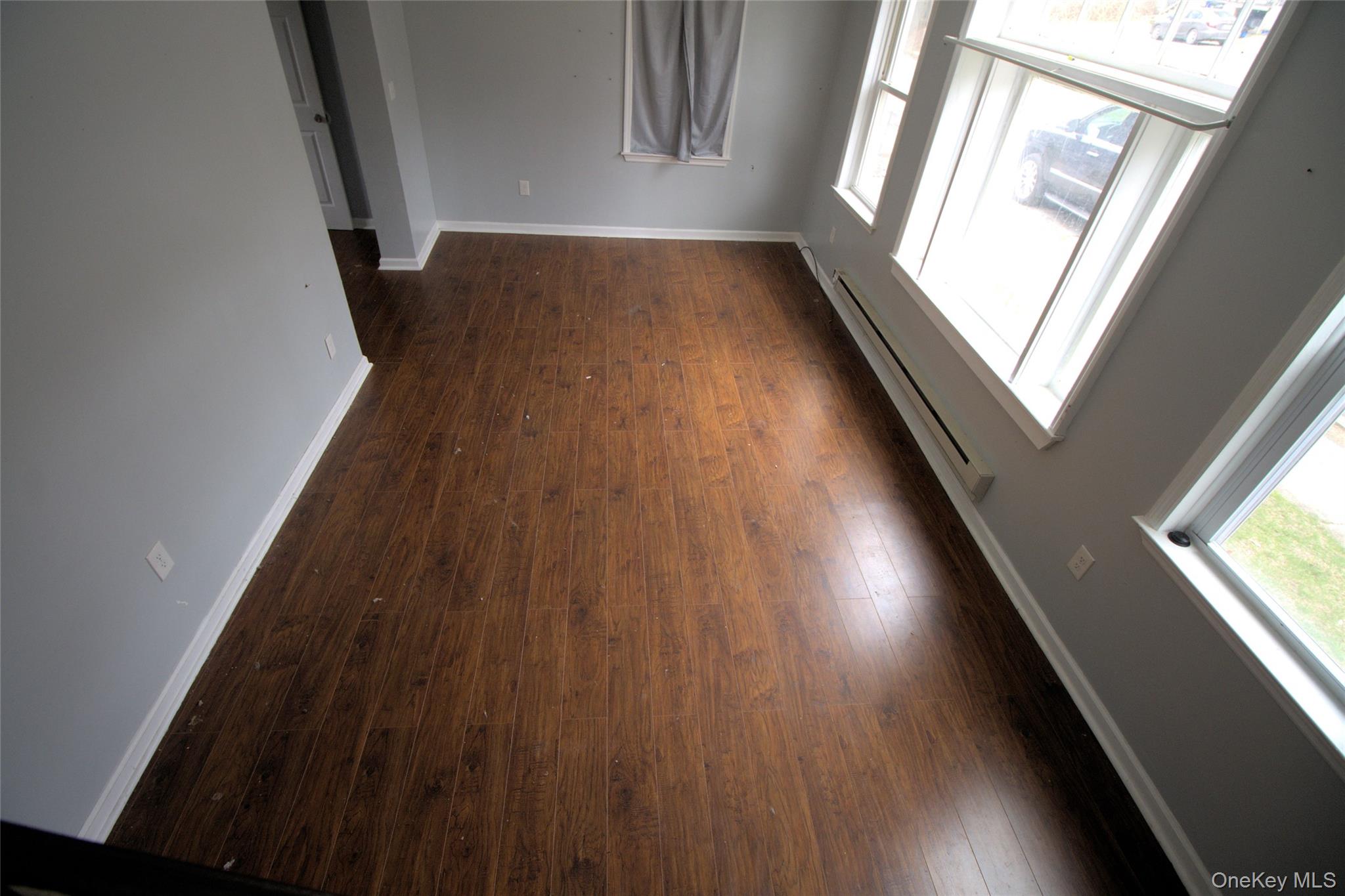 9 Spring Street Liberty, NY 12754 - Photo 25 of 29 Spacious room featuring wood-finish flooring, light grey walls, and white baseboards