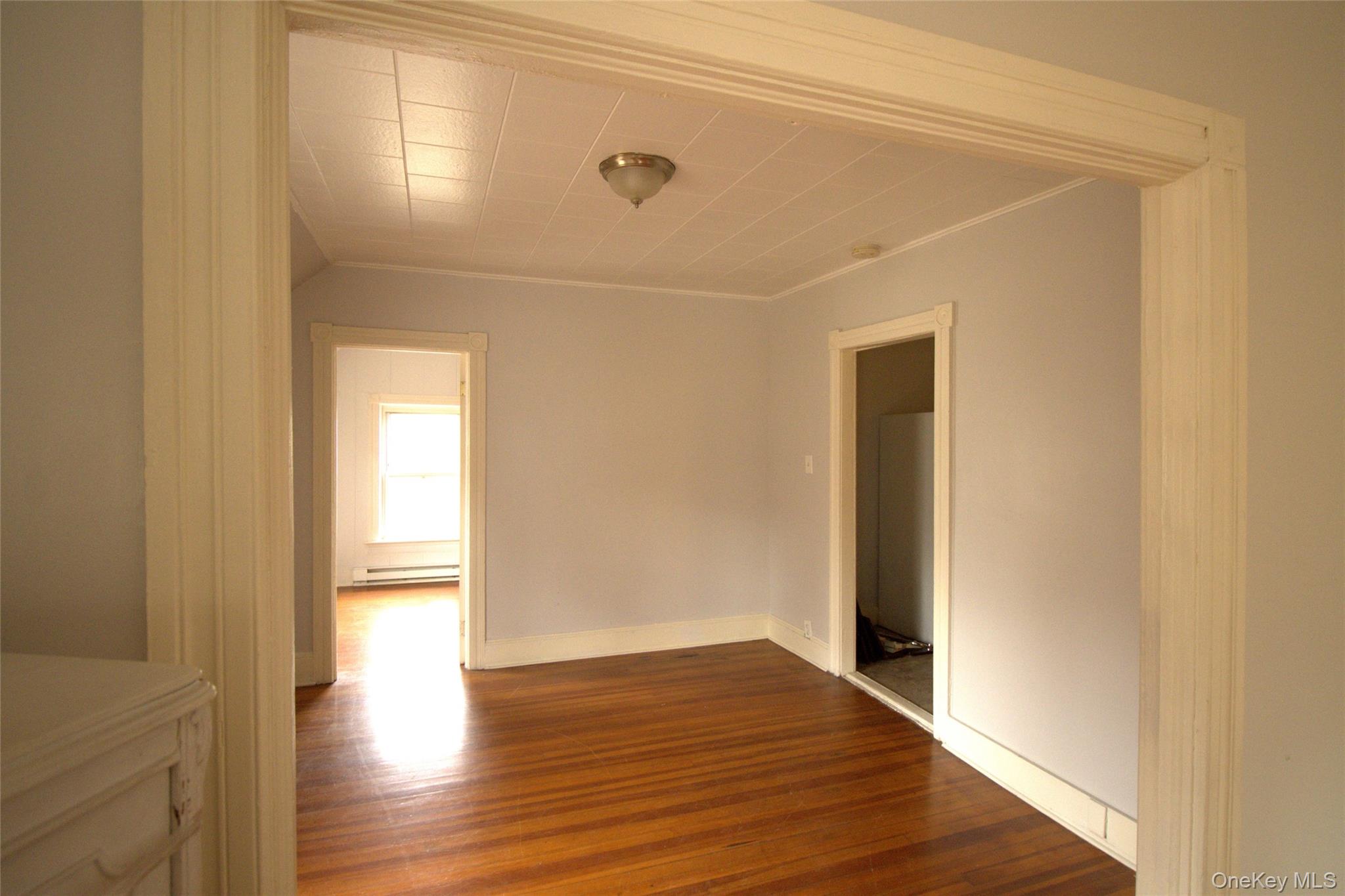9 Spring Street Liberty, NY 12754 - Photo 26 of 29 Spacious interior featuring wood-finish flooring, white baseboards, and light gray walls