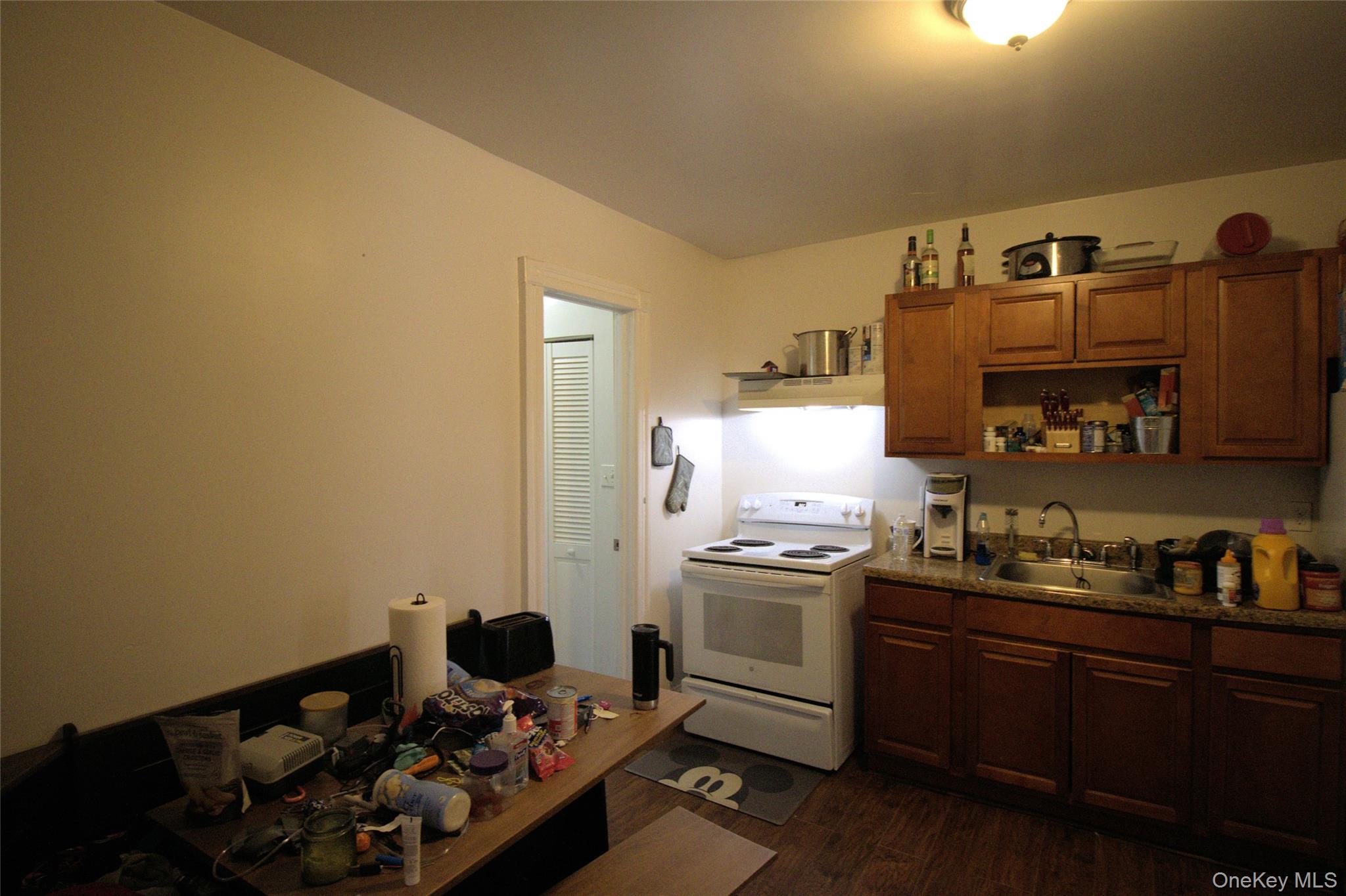 9 Spring Street Liberty, NY 12754 - Photo 6 of 29 Kitchen area featuring wood-finish flooring and a ceiling-mounted light fixture