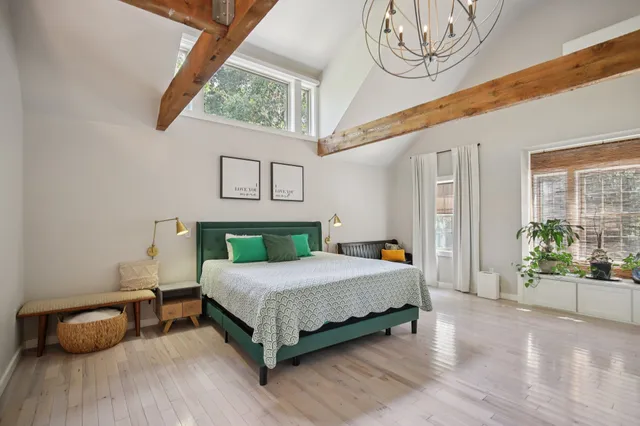 a bedroom with a bed and window