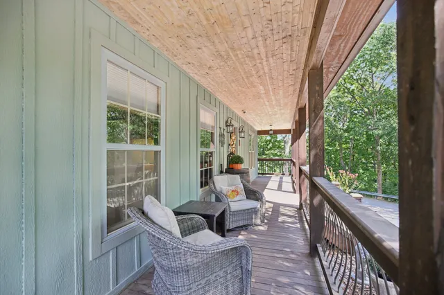 a bedroom with a bed a flat screen tv and a window