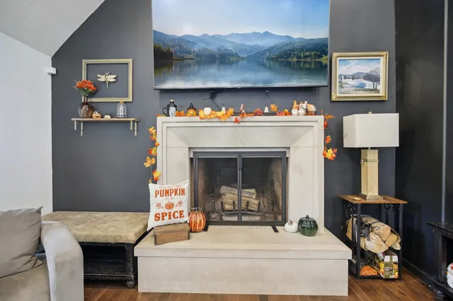 an aerial view of residential house with outdoor space and trees all around