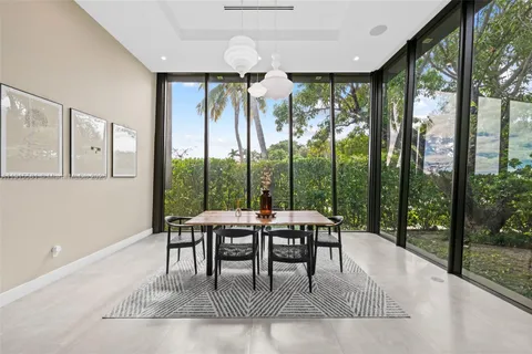 a work room with large glass windows and furniture