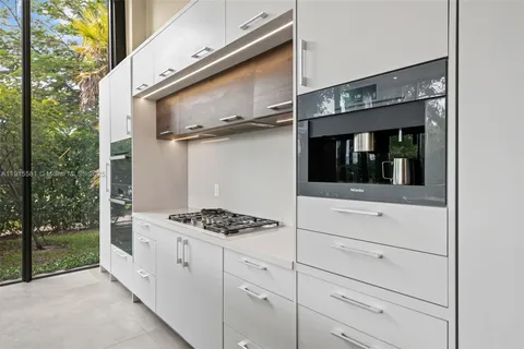 a kitchen with white cabinets and white appliances