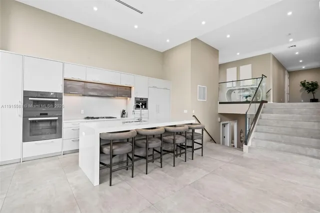 a view of kitchen with furniture and refrigerator