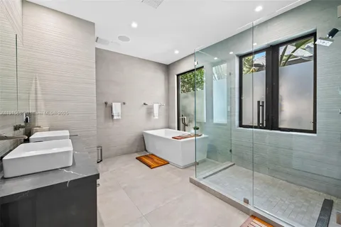 a bathroom with a sink mirror and a bathtub