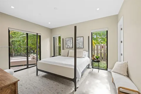 a bedroom with a bed and glass door